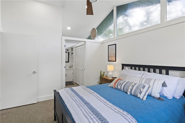 carpeted bedroom featuring high vaulted ceiling, ensuite bath, multiple windows, and ceiling fan