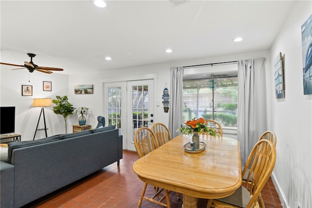 tiled dining space with ceiling fan