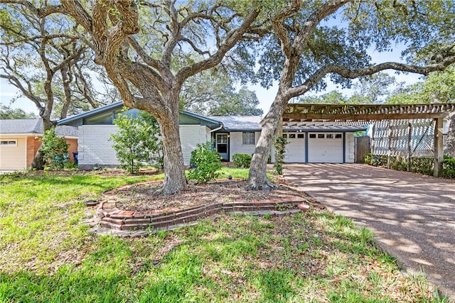 single story home featuring a garage and a front yard