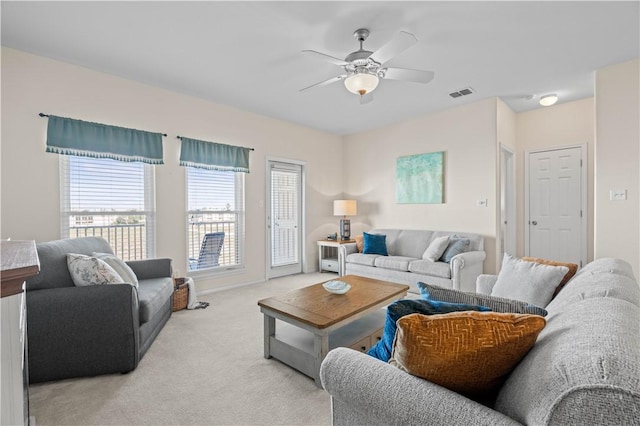 carpeted living room featuring ceiling fan