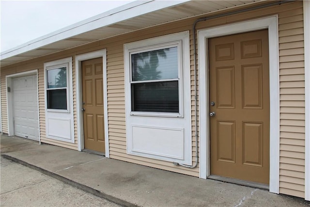 view of exterior entry with a garage