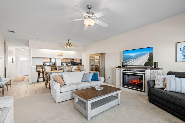 living room featuring ceiling fan and light tile patterned floors