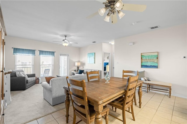 tiled dining area with ceiling fan