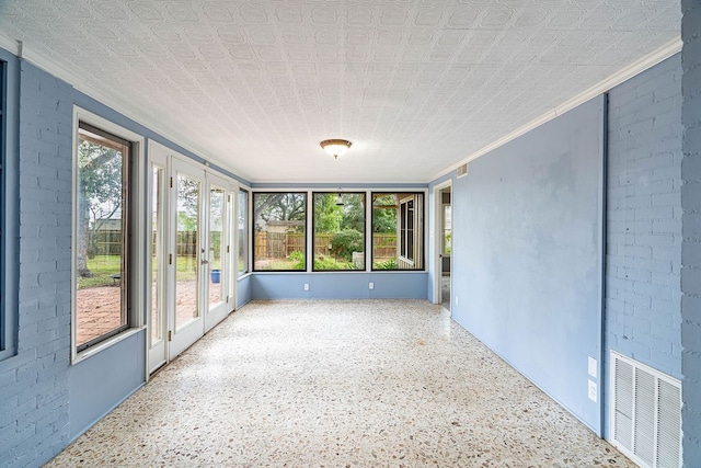 unfurnished sunroom featuring a healthy amount of sunlight