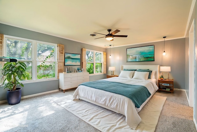 carpeted bedroom featuring ornamental molding, multiple windows, and ceiling fan