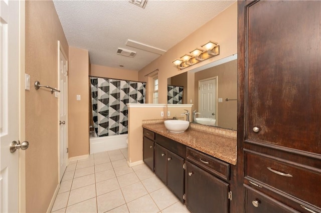 full bathroom featuring vanity, tile patterned floors, shower / bath combination with curtain, and a textured ceiling