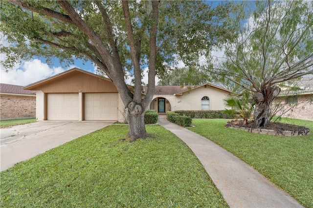 single story home featuring a garage and a front lawn