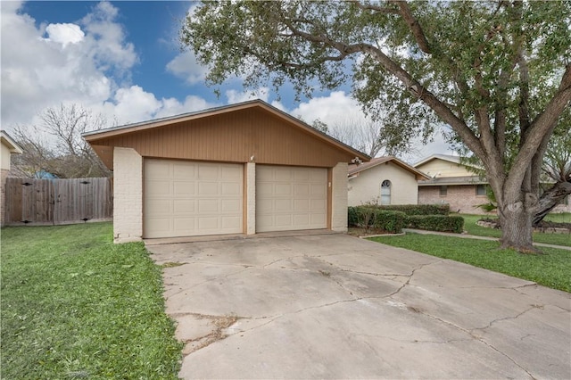 ranch-style house featuring a garage, an outbuilding, and a front lawn