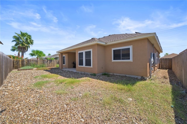 13822 Whitecap Blvd, Corpus Christi, TX 78418 - rear view of house with a fenced backyard and stucco siding
