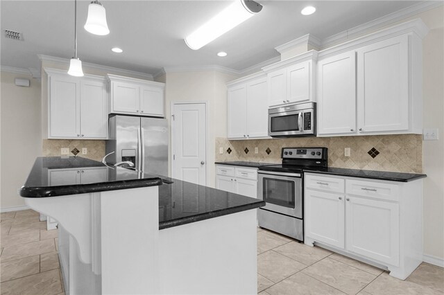 13822 Whitecap Blvd, Corpus Christi, TX 78418 - kitchen with stainless steel appliances, crown molding, white cabinetry, an island with sink, and pendant lighting