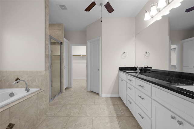 13822 Whitecap Blvd, Corpus Christi, TX 78418 - bathroom with ceiling fan, double vanity, a stall shower, a garden tub, and a walk in closet