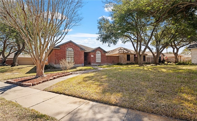 single story home featuring a front lawn