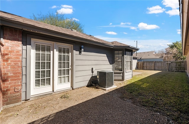 exterior space with a yard and central air condition unit