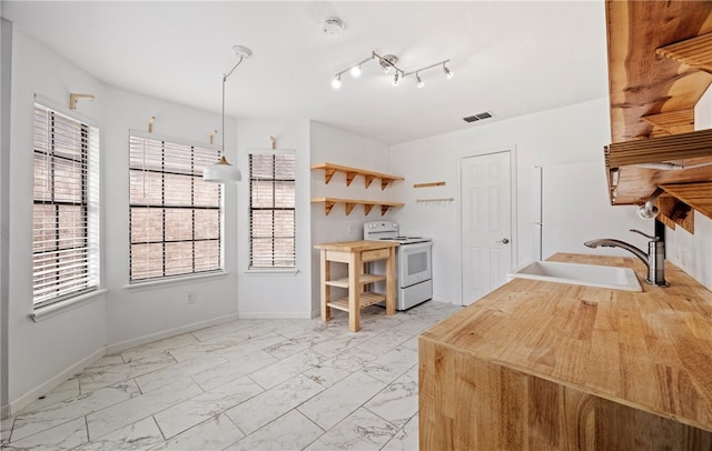 kitchen with white electric stove and sink