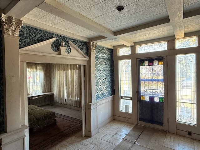 doorway to outside featuring beam ceiling