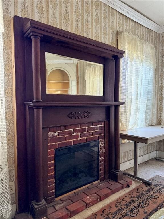 details with ornamental molding and a brick fireplace