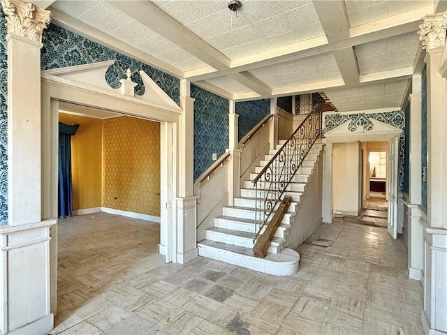 interior space with beam ceiling, parquet floors, and coffered ceiling