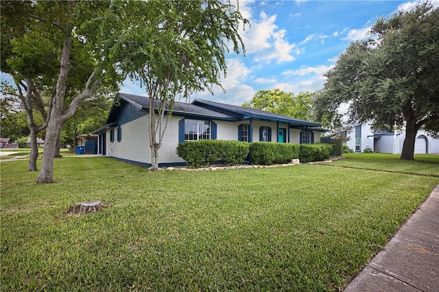 ranch-style house featuring a garage and a front yard