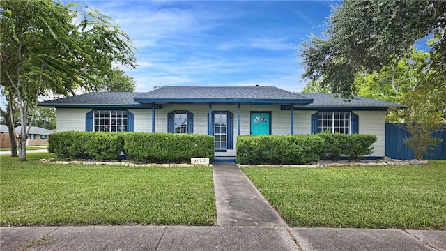 ranch-style home featuring a front yard