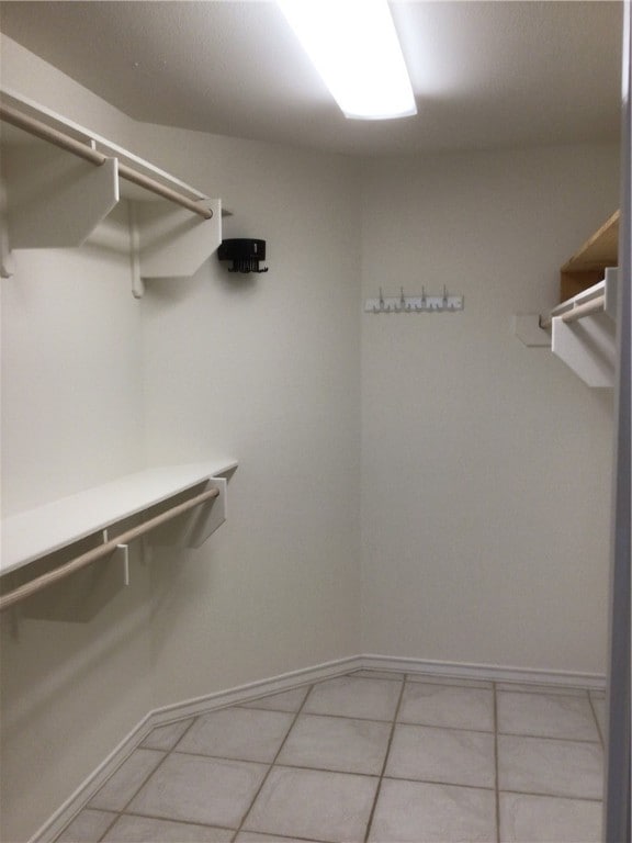 spacious closet featuring light tile patterned flooring