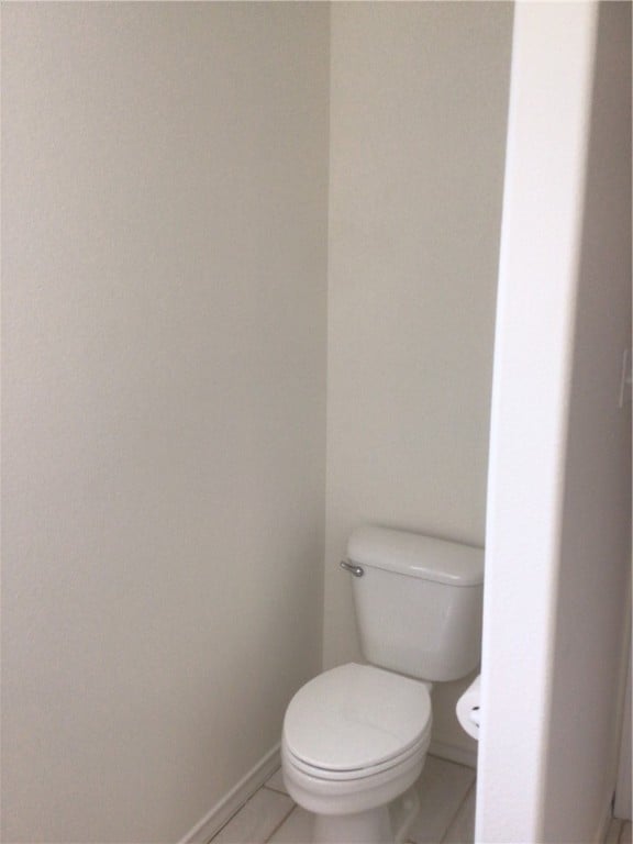 bathroom featuring tile patterned flooring and toilet