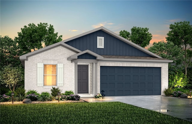 view of front of house with a garage and a yard