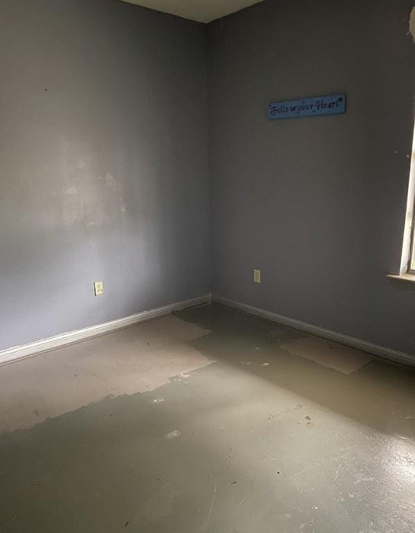 spare room with baseboards