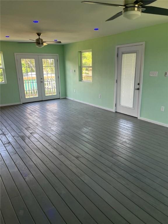 1123 S Fuqua St, Rockport, TX 78382 - unfurnished living room featuring ceiling fan, baseboards, french doors, and dark wood-style flooring