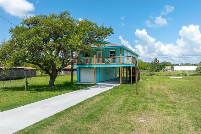 1123 S Fuqua St, Rockport, TX 78382 - rear view of house featuring a deck, a garage, driveway, and a carport