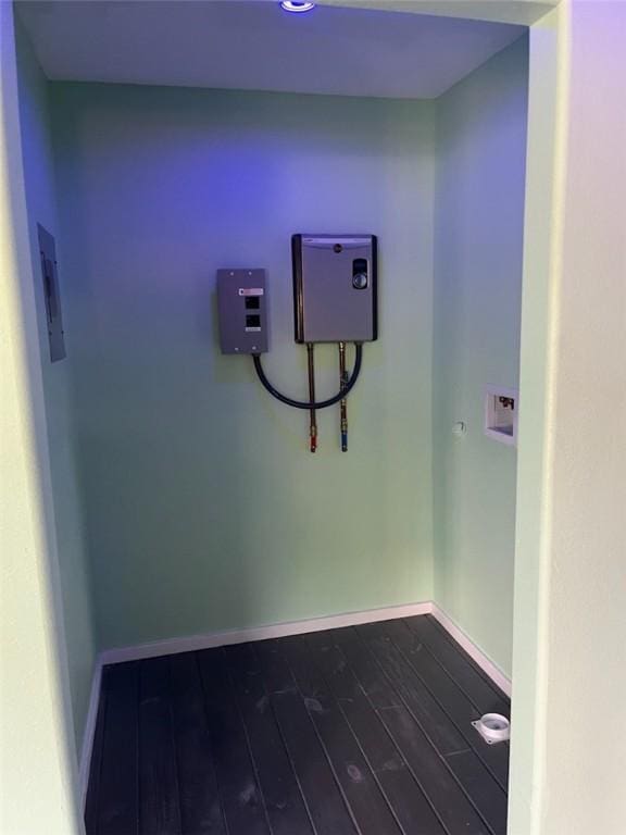 1123 S Fuqua St, Rockport, TX 78382 - laundry room featuring dark wood finished floors, electric panel, and baseboards