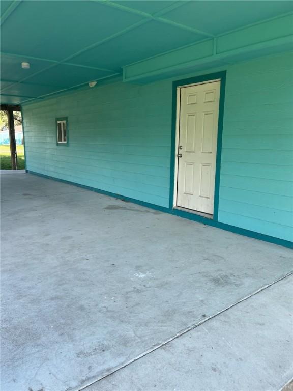 1123 S Fuqua St, Rockport, TX 78382 - property entrance with an attached carport