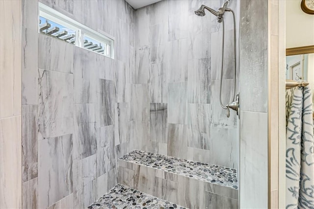 bathroom with tiled shower