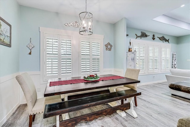 dining room featuring wood-type flooring and a chandelier