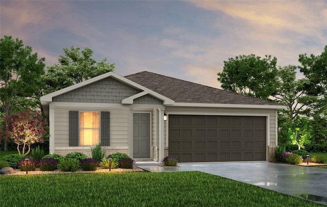 view of front of house featuring a garage and a yard