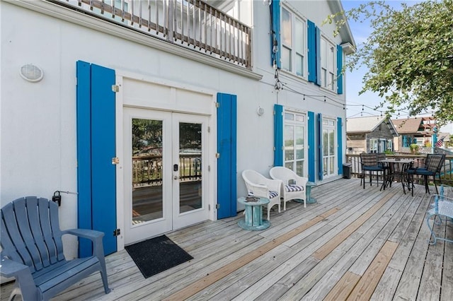 207 S 2nd St, Rockport, TX 78382 - wooden deck featuring french doors and outdoor dining space