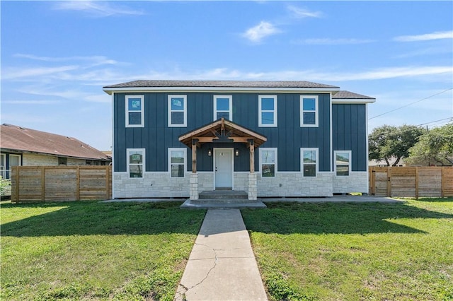 1101 6th St, Corpus Christi, TX 78404 - view of front facade featuring board and batten siding, stone siding, and a fenced backyard