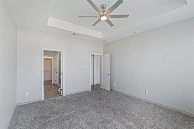 3406 Angelina St, Corpus Christi, TX 78414 - unfurnished bedroom featuring a raised ceiling, carpet, and a ceiling fan