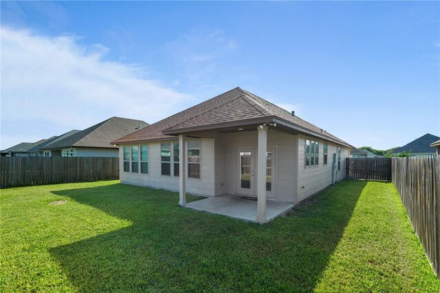 3406 Angelina St, Corpus Christi, TX 78414 - rear view of house with a fenced backyard, a patio, and a shingled roof