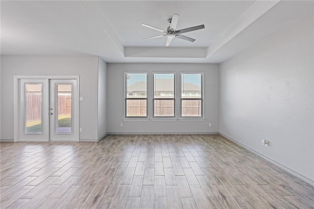 3406 Angelina St, Corpus Christi, TX 78414 - spare room with a tray ceiling, ceiling fan, light wood-style flooring, and french doors
