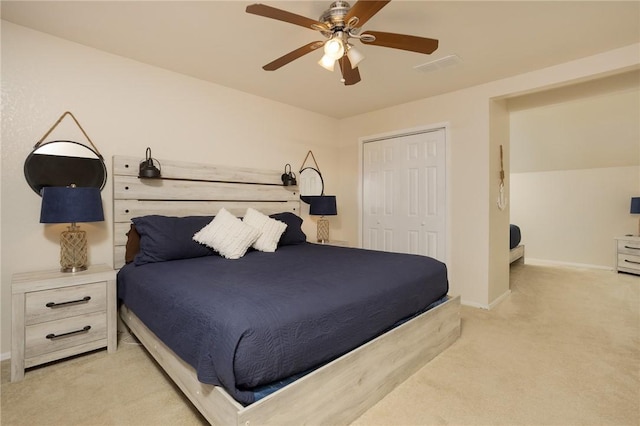 bedroom featuring a ceiling fan, baseboards, a closet, and light colored carpet