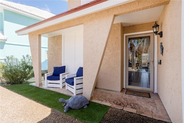 property entrance with stucco siding