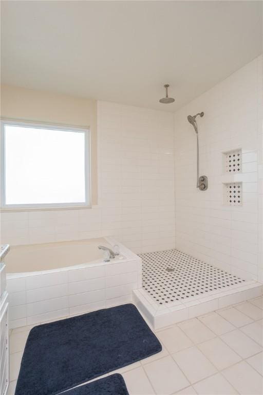 bathroom featuring a tile shower and a bath