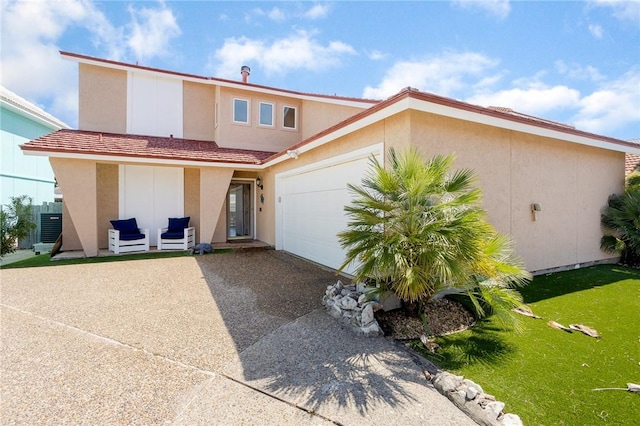 view of front facade with driveway, central air condition unit, an attached garage, and stucco siding