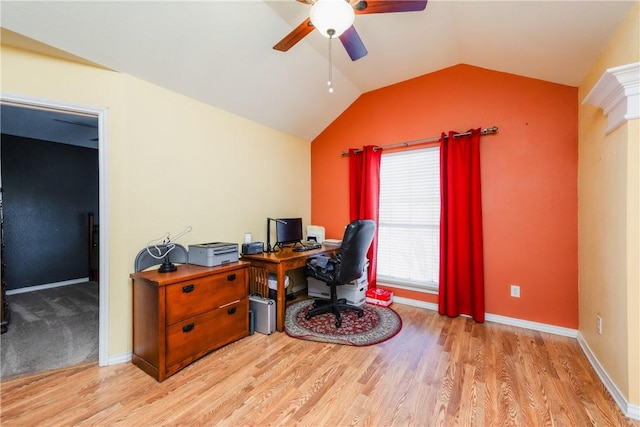 home office with baseboards, wood finished floors, a ceiling fan, and vaulted ceiling