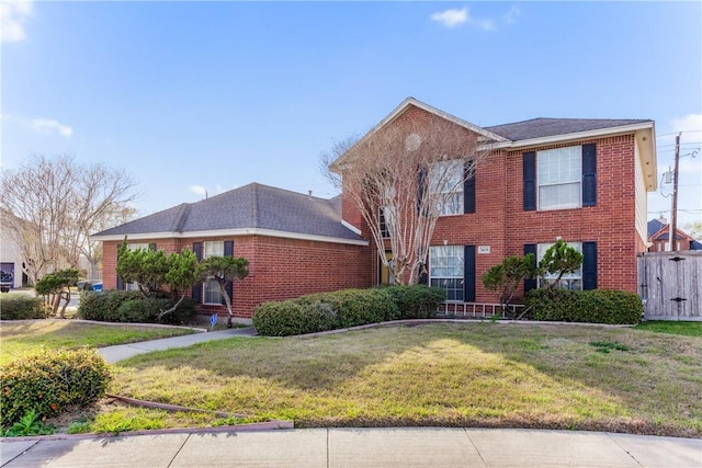 view of front of home featuring brick siding and a front yard