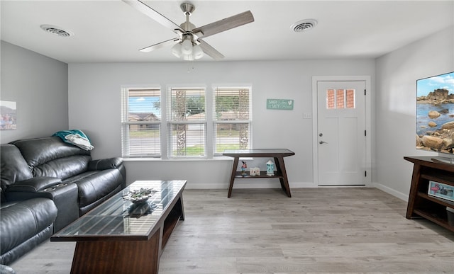 living room with light wood-type flooring and ceiling fan