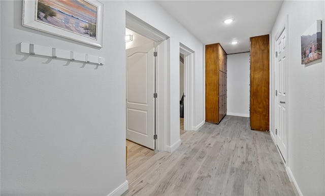 hall with light hardwood / wood-style floors