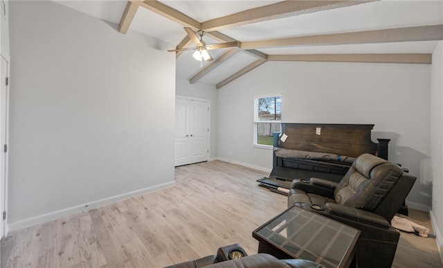 living room featuring ceiling fan, lofted ceiling with beams, and light wood-type flooring