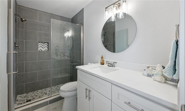 bathroom featuring vanity, an enclosed shower, and toilet