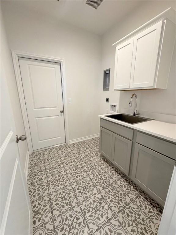 2550 Las Estrellas St, Corpus Christi, TX 78414 - laundry area with hookup for an electric dryer, cabinet space, washer hookup, and baseboards